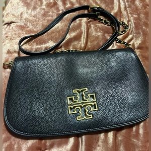 Tory Burch black and gold cross body  clutch gently used in very good condition.